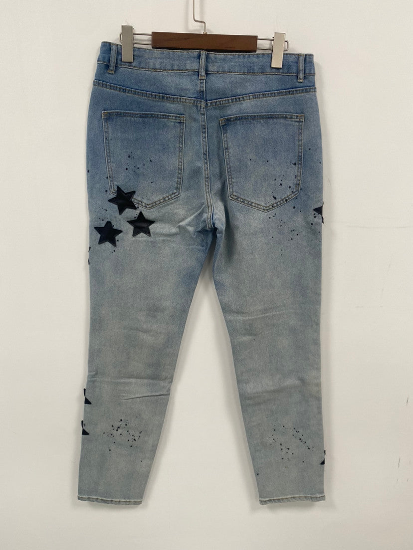 Jeans strappati da uomo con toppa a stella ricamata