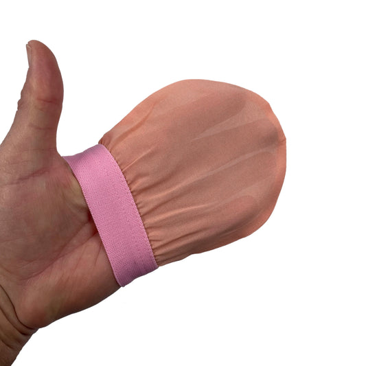 Plant-based silk Turkish exfoliating bath glove worn on hand for smooth glowing skin