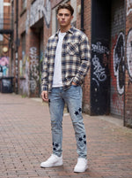 Jeans strappati da uomo con toppa a stella ricamata